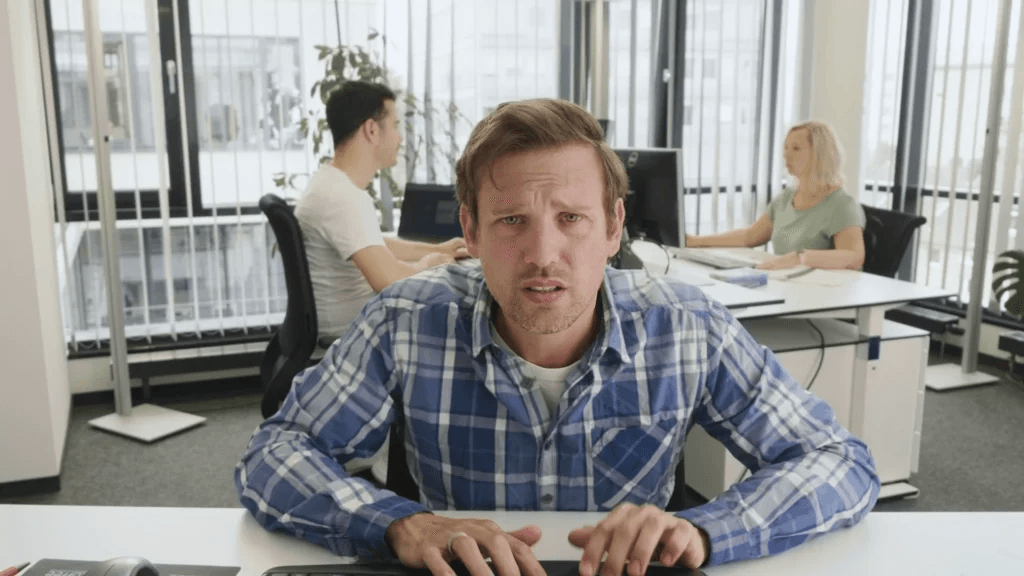 Verzweifelter Mann vor Rechner Ein frustrierter Mann sitzt verzweifelt vor seinem Computer